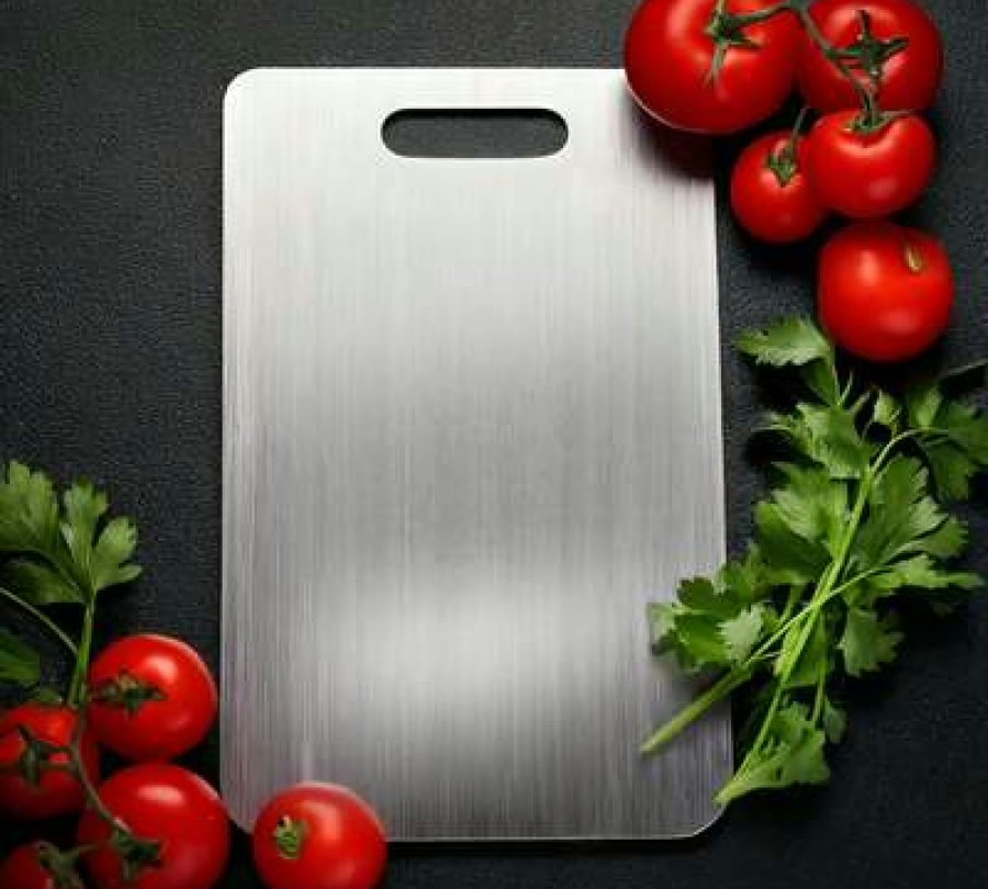 Katori pure titanium cutting board on a dark surface with fresh tomatoes and parsley